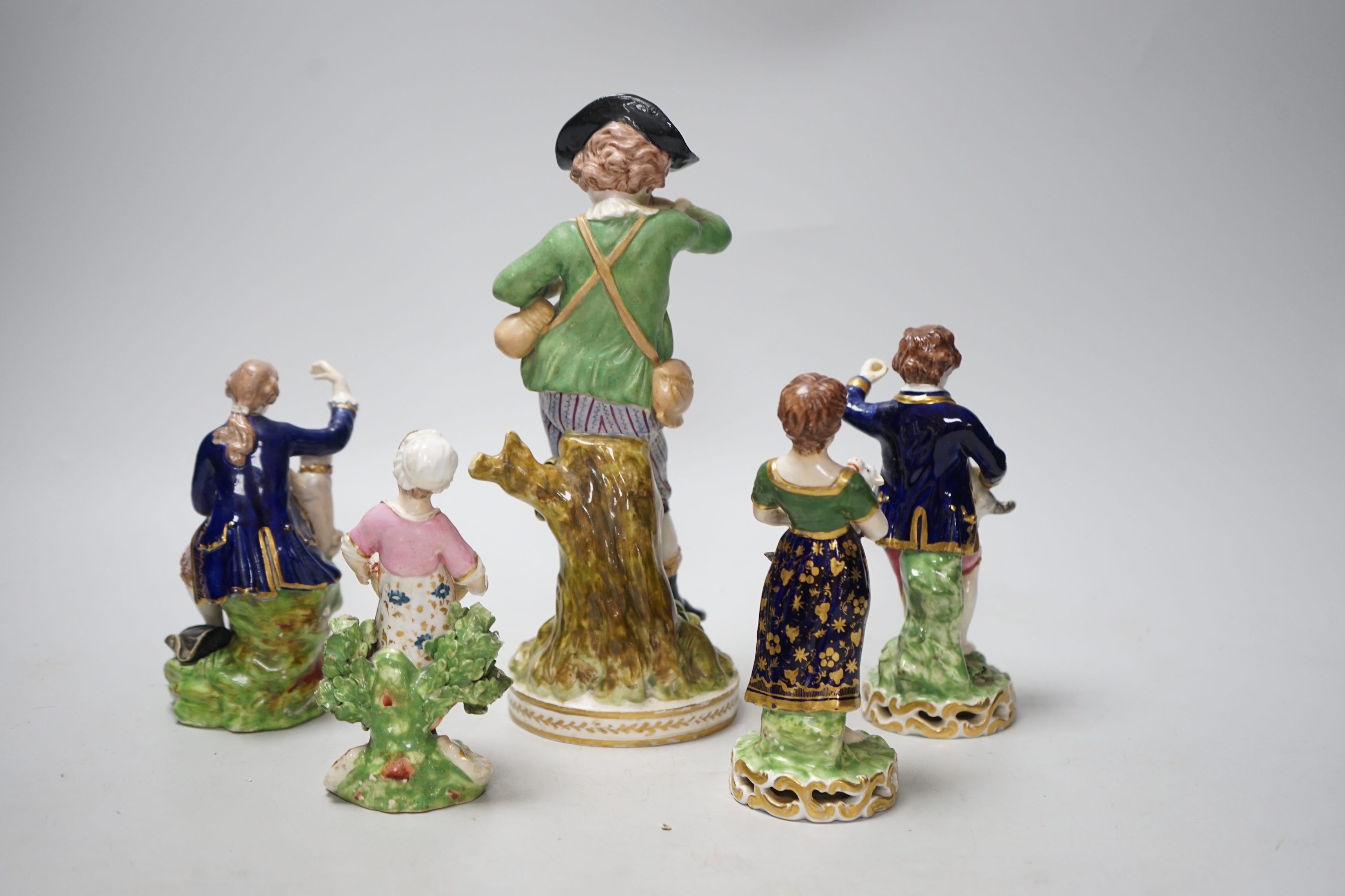 Four early 19th century Derby figures and an English porcelain figure in imitation of Derby, tallest 23cm